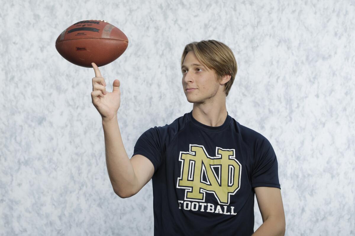 Notre Dame High football player Joey Santorico spins a football on his finger.
