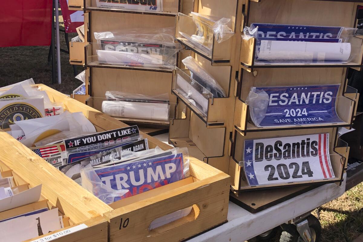Bumper stickers reading "Trump won" and "DeSantis 2024" for sale in display boxes