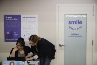 FILE - Dental assistants go over appointments at SmileDirectClub's SmileShop located inside a CVS store April 24, 2019, in Downey, Calif. SmileDirectClub is shutting down, just months after the struggling teeth-straightening company filed for bankruptcy, leaving existing customers in limbo. On Friday, Dec. 8, 2023, the company said it was unable to find a partner willing to bring in enough capital to keep the company afloat, despite a months-long search. (AP Photo/Jae C. Hong)