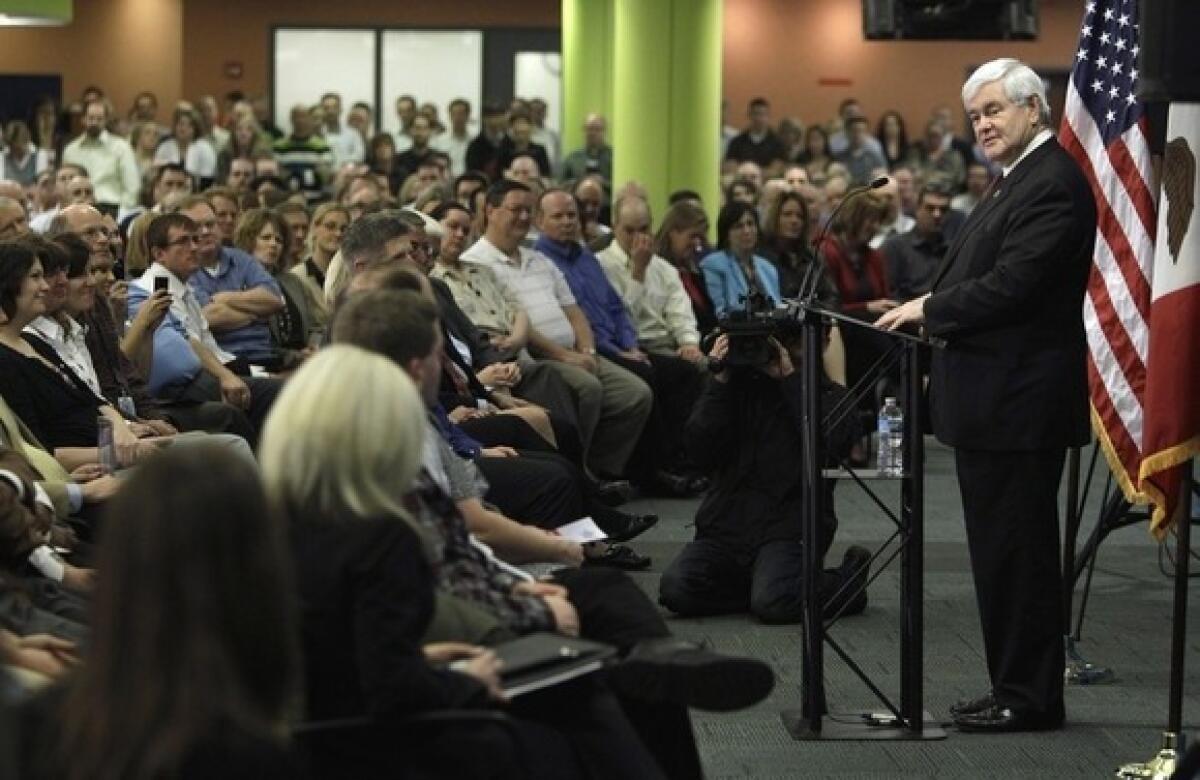 Newt Gingrich talks to employees at an insurance company in Des Moines on Thursday.