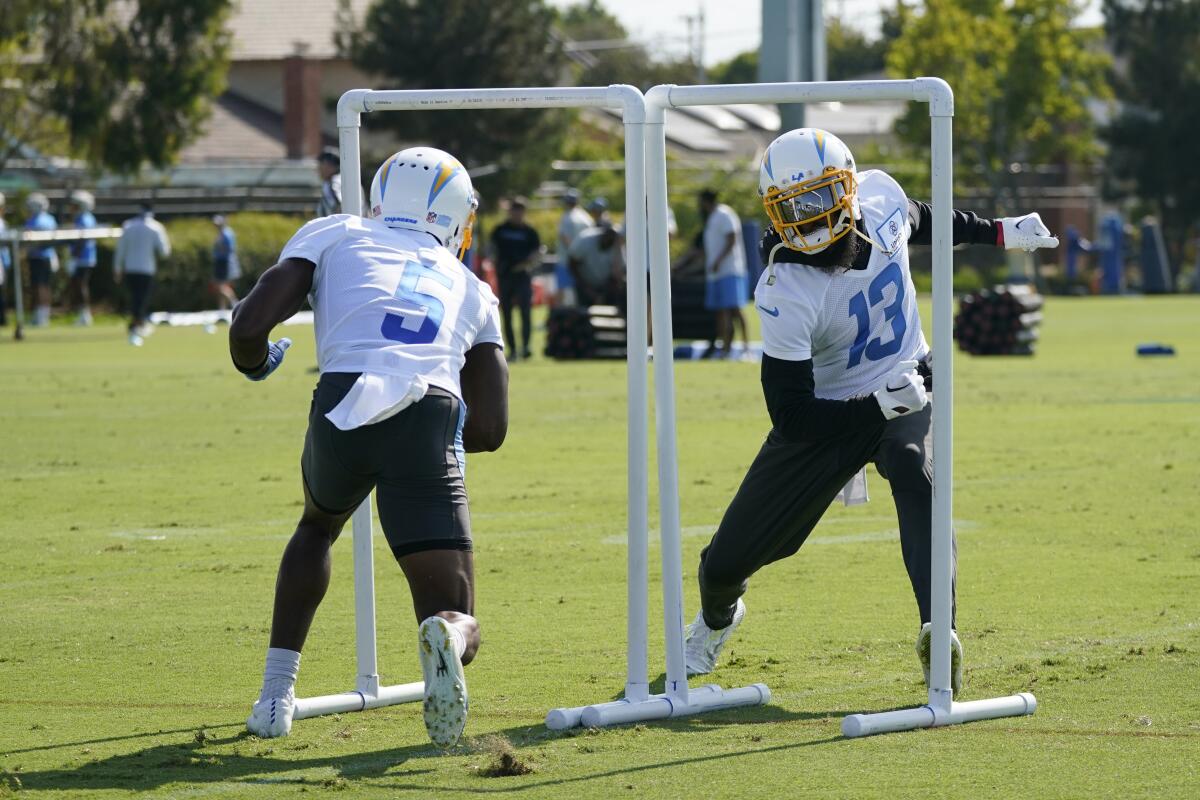 Chargers receivers Joshua Palmer (5) and Keenan Allen take part in a drill at training camp.