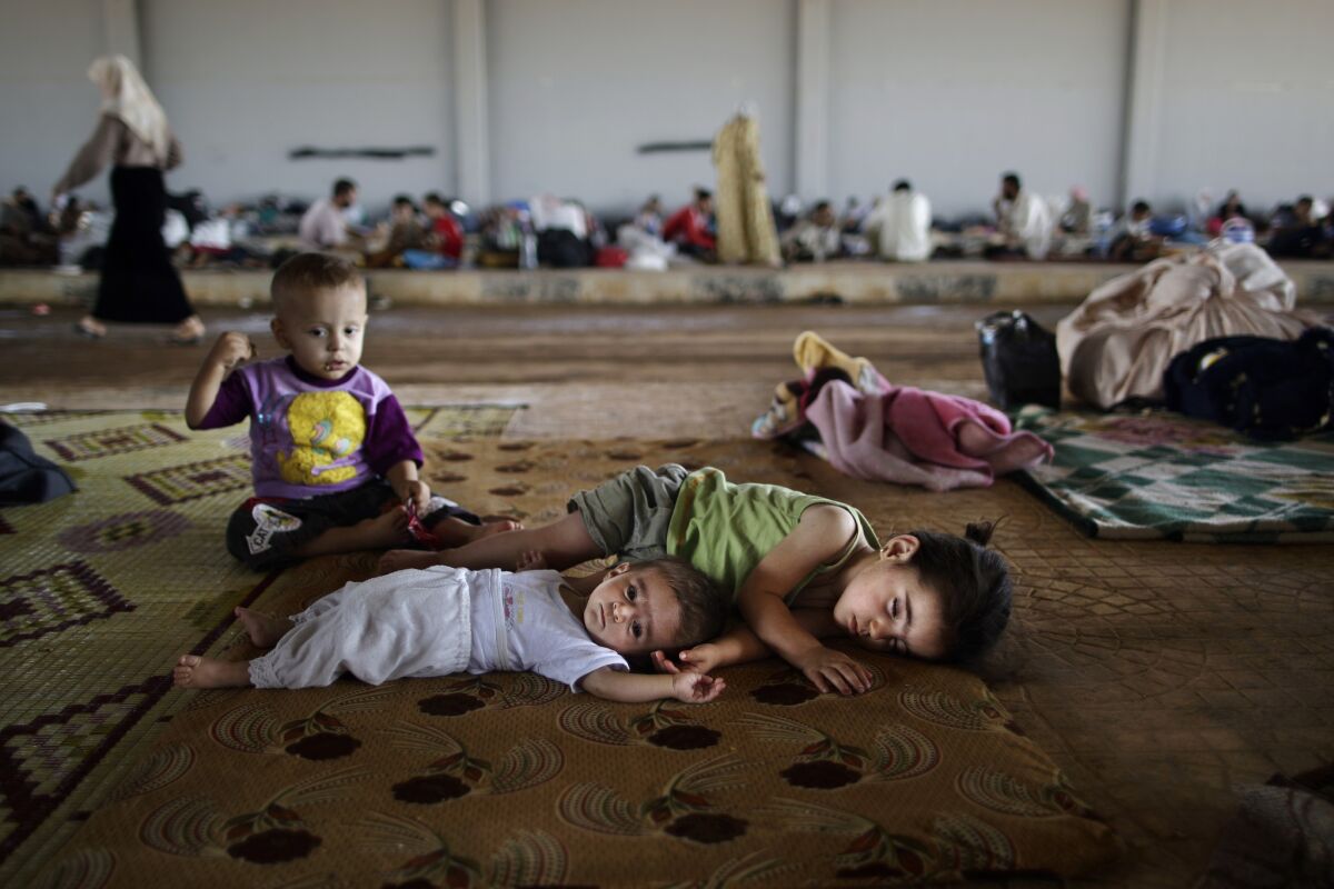 Syrian children at a makeshift refugee camp at the Bab al-Salameh border crossing, a way station for those hoping to cross into Turkey to escape the war.