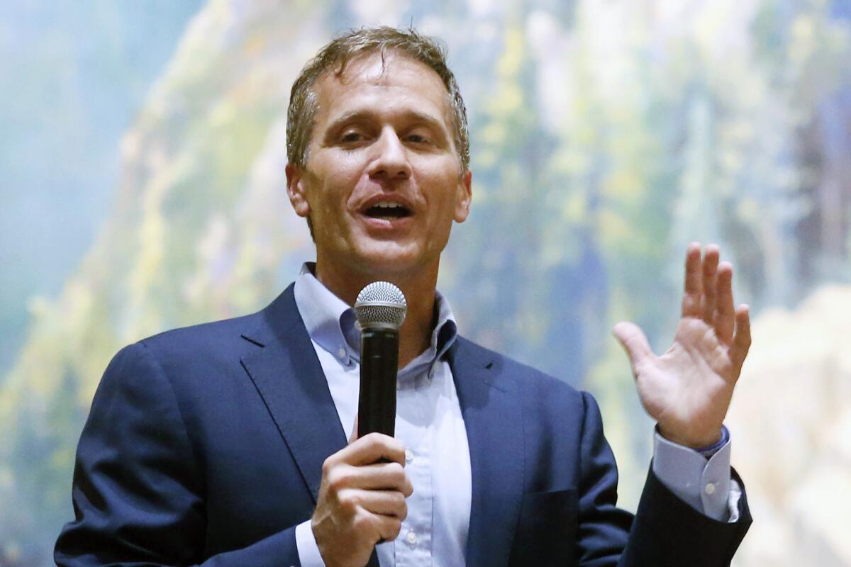 Former Missouri Gov. Eric Greitens speaks into a microphone. 