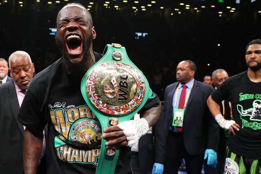 NEW YORK, NEW YORK - MAY 18: Deontay Wilder celebrates after his first round knockout of Dominic Breazeale who looks on in the first round during their bout for Wilder's WBC heavyweight title at Barclays Center on May 18, 2019 in New York City. (Photo by Al Bello/Getty Images) ** OUTS - ELSENT, FPG, CM - OUTS * NM, PH, VA if sourced by CT, LA or MoD **