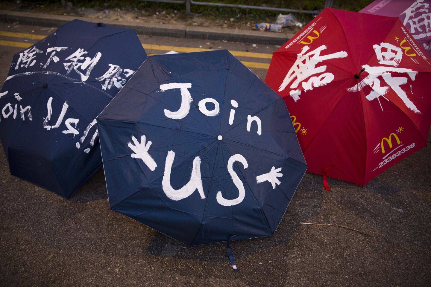 Umbrellas are painted with slogans at the protest site as the numbers of protesters continue to grow in Hong Kong.
