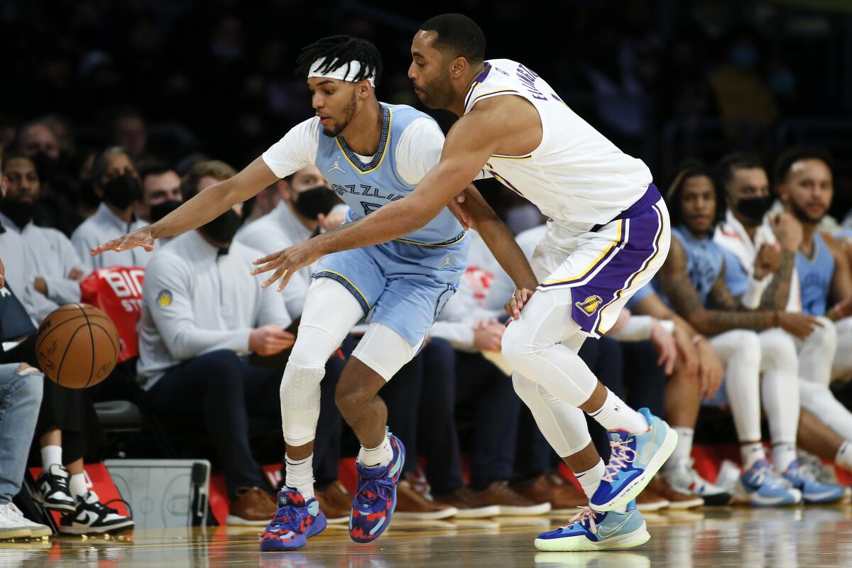 Lakers guard Wayne Ellington, right, knocks the ball away from Memphis Grizzlies guard Ziaire Williams.