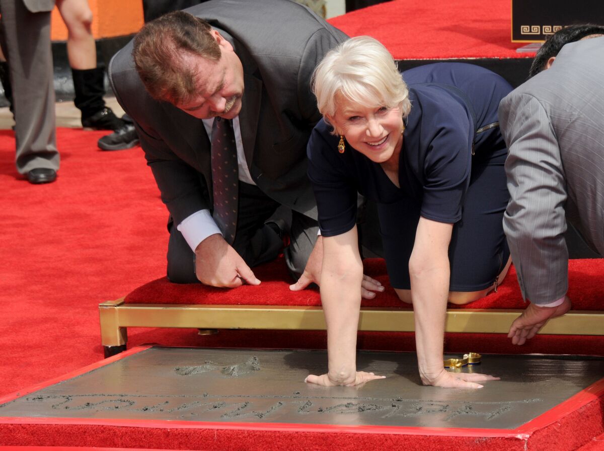 Helen Mirren gets her hand and footprints immortalized in cement at Grauman's Chinese Theatre on March 28, 2011 in Hollywood. (Gregg DeGuire / FilmMagic)