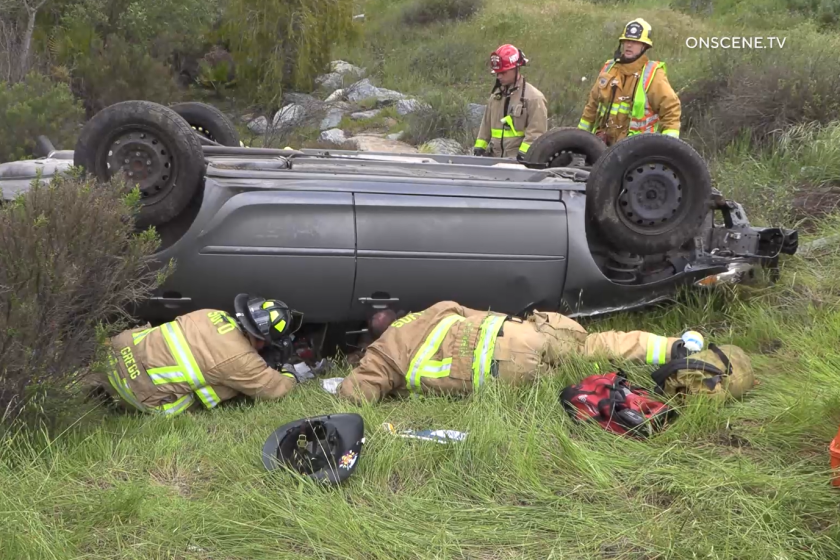 Firefighters worked to free a driver whose car crashed and overturned near a river bottom along Mission Gorge Road in Santee late Monday morning.