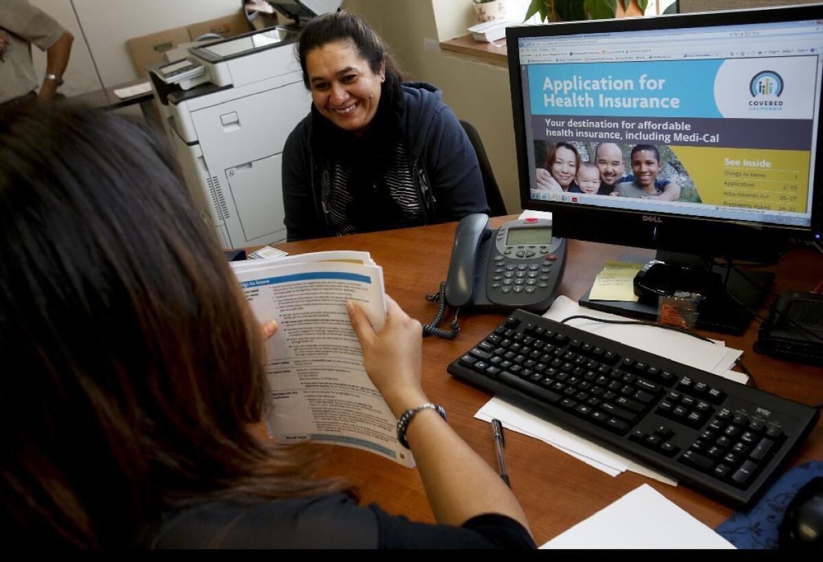 Marta Viera signs up for Obamacare at a Los Angeles clinic in November. The state's online enrollment system was back up Monday after an outage.