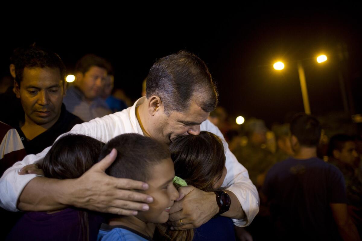 Ecuador's President Rafael Correa kisses a group of children after meeting with local authorities in the emergency center in Portoviejo, Ecuador.