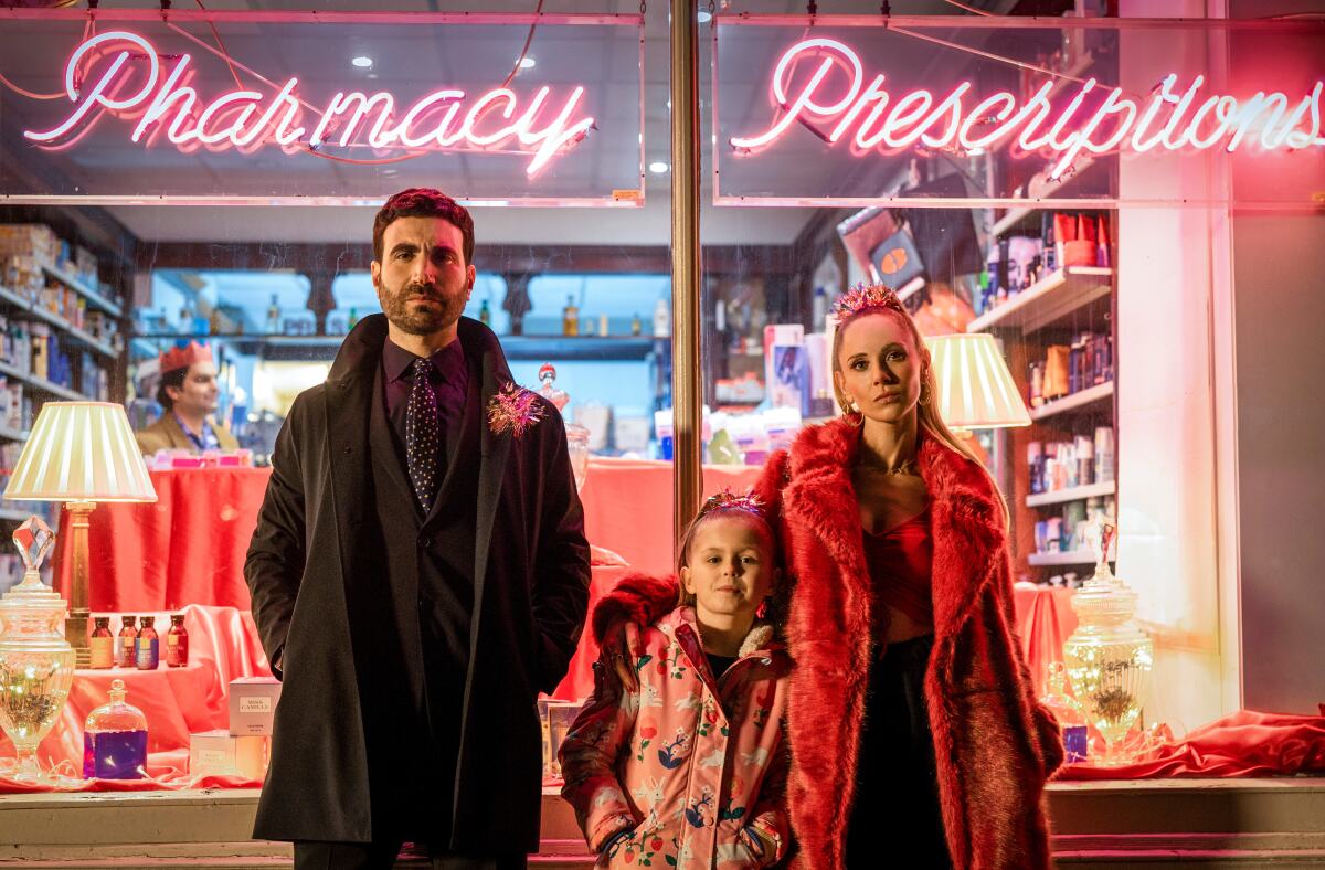 Brett Goldstein, Elodie Blomfield and Juno Temple stand in front of a pharmacy window in a scene from "Ted Lasso."