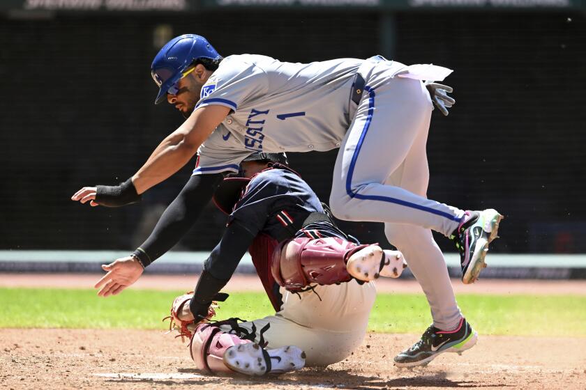 Kansas City Royals' MJ Melendez (1) scores over Cleveland Guardians catcher Bo Naylor on a fielder's choice hit by Kyle Isbel during the sixth inning of a baseball game, Thursday, June 6, 2024, in Cleveland. (AP Photo/Nick Cammett)