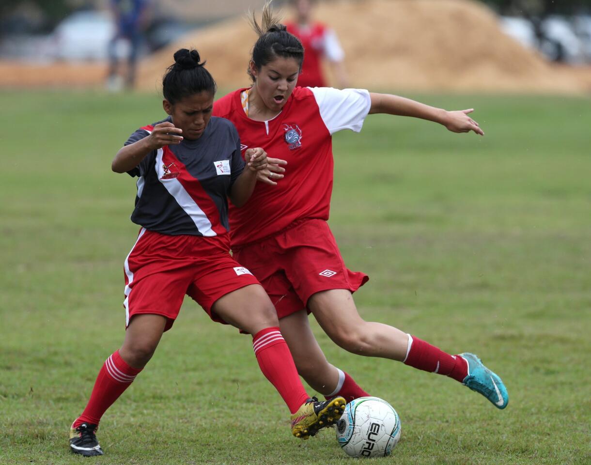 Indigenous players, Canadian Jasmine Hunt, right, and Peru's Kelly Ochoa fight for the ball during a soccer game at the World Indigenous Games in Palmas, Brazil, Wednesday, Oct. 28, 2015. Organizers billed the nine-day-long event as a sort of indigenous Olympics. But for many of the participants from some 20 countries, the sports themselves appear to be taking a back seat to what they say really matters _ cross-cultural sharing and learning. (AP Photo/Eraldo Peres)