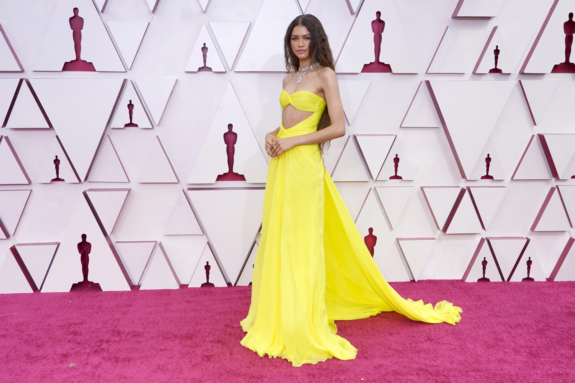 Zendaya in a yellow gown with exposed midriff