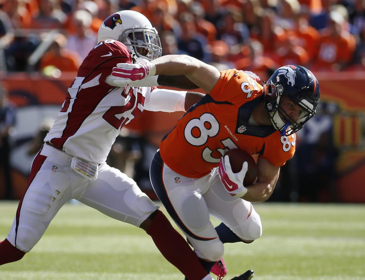 Denver Broncos wide receiver Wes Welker (83) is tackled by Arizona Cardinals cornerback Jerraud Powers during the first half of an NFL football game on Oct. 5, 2014. Welker not only showed up at Del Mar in 2013, but he also had a horse named Undrafted that ran that day, according to the San Diego Union Tribune.