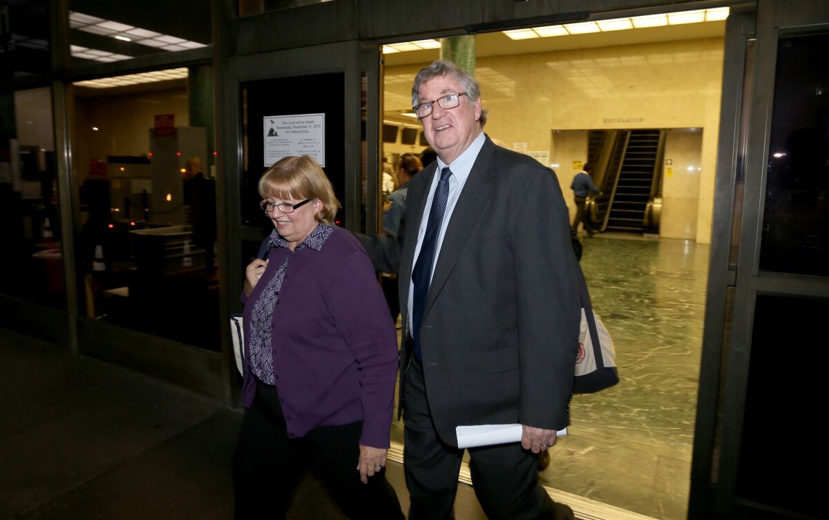 Former Los Angeles Times sports columnist T.J. Simers and his wife, Ginny, leave the Stanley Mosk Courthouse in Los Angeles after winning a $7.1-million judgment in an age bias lawsuit against his former employer, the Los Angeles Times, on Wednesday, Nov. 4, 2015.