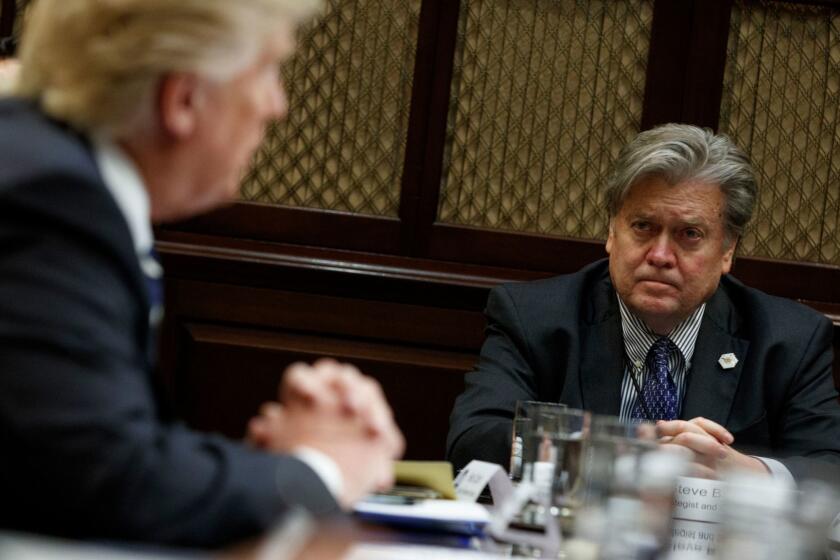 Then-White House Chief Strategist Steve Bannon listens as President Donald Trump speaks during a meeting on cyber security in the Roosevelt Room of the White House in Washington, Tuesday, Jan. 31, 2017. (AP Photo/Evan Vucci, File)