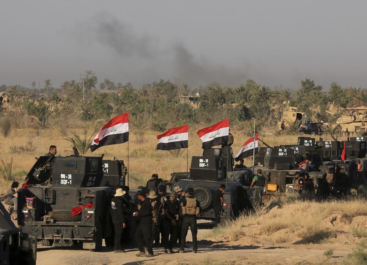 Smoke billows on the horizon as Iraqi military forces prepare for an offensive to retake Fallouja from Islamic State militants in Iraq on May 30, 2016.