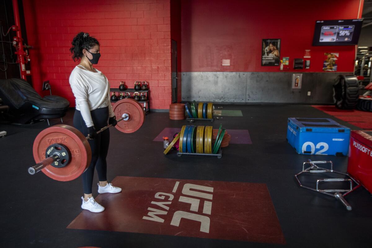 Anahiz Cortez lifts weights at the UFC Gym in La Mirada.