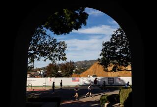 Runners pass the site where Community United Methodist Church of Pacific Palisades once stood.