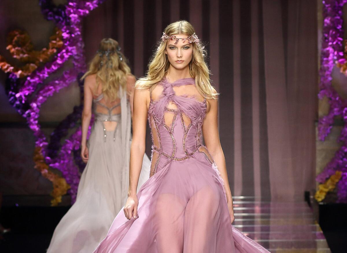 Model Karlie Kloss presents a creation from the Fall/Winter 2015/2016 Haute Couture collection by Italian designer Donatella Versace during Paris Fashion Week.