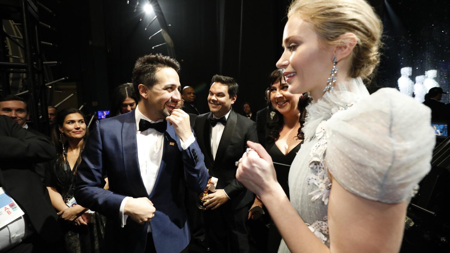 Lin-Manuel Miranda, Robert Lopez and Kristen Anderson-Lopez, with presenter Emily Blunt after winning for original song, backstage at the 90th Academy Awards on Sunday at the Dolby Theatre in Hollywood.