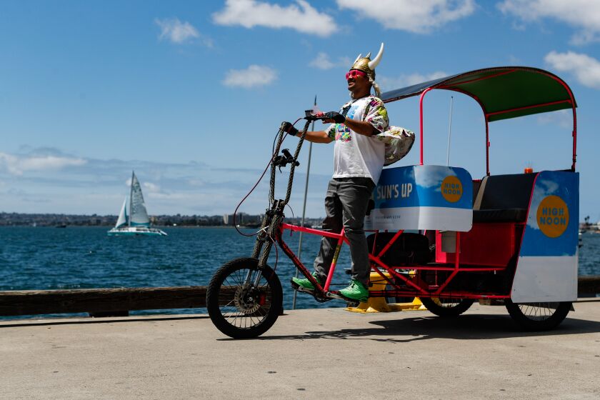San Diego, CA - May 10: Riza Korkusuz, known as @vikingpedicablife on Instagram, searches for customers on Wednesday, May 10, 2023 in San Diego, CA. The Port of San Diego is considering outlawing pedicabs, scooters, e-bikes and other motorized vehicles from all pedestrian areas. (Meg McLaughlin / The San Diego Union-Tribune)