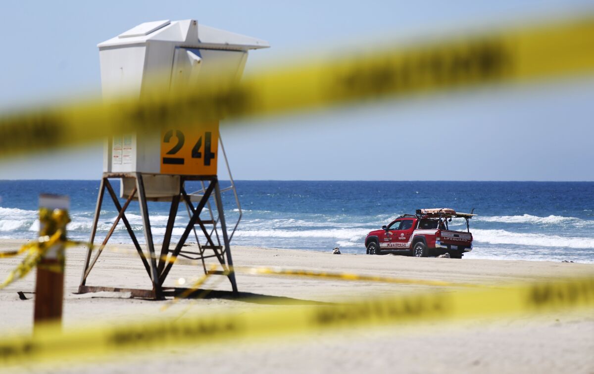 A San Diego Lifeguard patrols a closed Pacific Beach on March 30, 2020. San Diego beaches, parks and trails were closed due to the coronavirus.