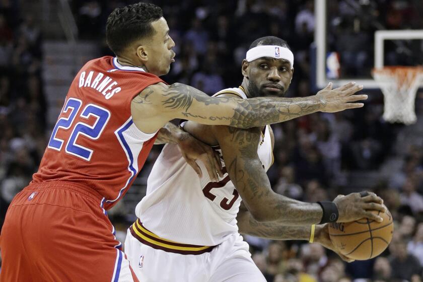 Clippers forward Matt Barnes (22) pressures Cavaliers forward LeBron James as he looks to pass.