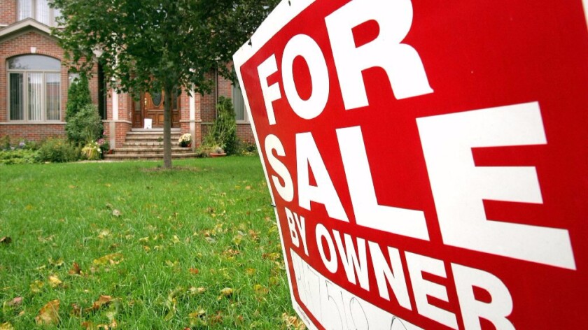 A "For Sale By Owner" sign in front of a single-family residence in Park Ridge, Ill.