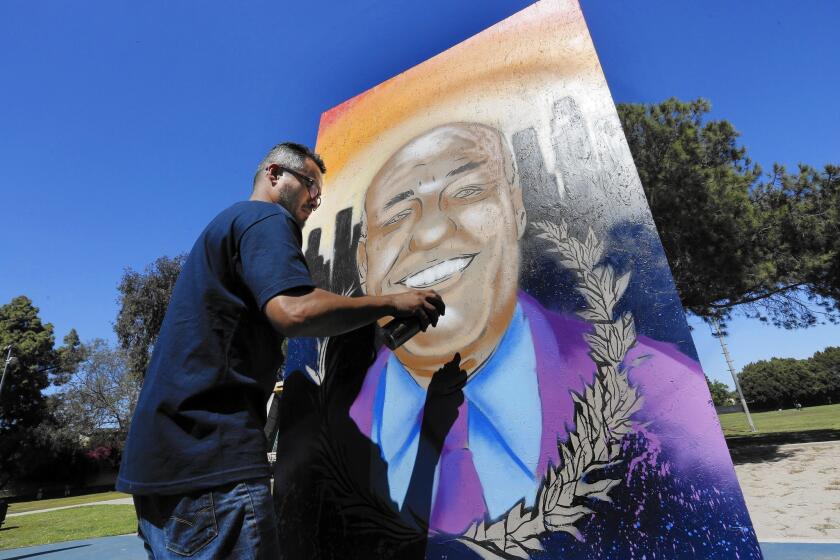 Hector Gardea paints a mural of late Los Angeles City Council member Bill Rosendahl at Mar Vista park on Saturday during a celebration of Rosendahl's life.