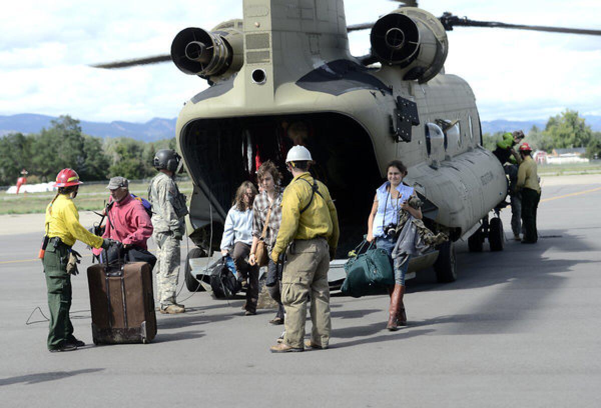 Residents evacuated from Jamestown, Colo., arrive at Boulder Municipal Airport.