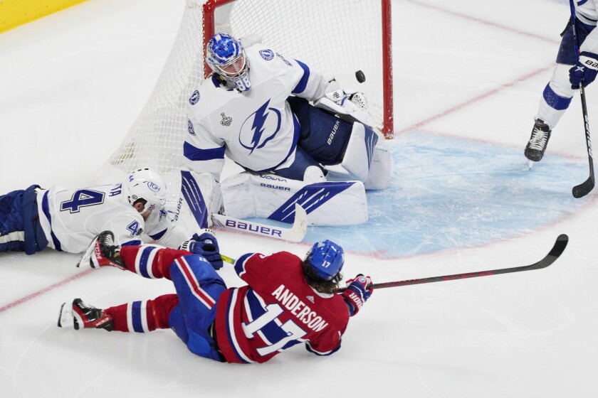 Montreal Canadiens right wing Josh Anderson (17) scores past Tampa Bay Lightning goaltender Andrei Vasilevskiy (88) as Lightning defenseman Jan Rutta (44) defends during overtime of Game 4 of the NHL hockey Stanley Cup final in Montreal, Monday, July 5, 2021. (Paul Chiasson/The Canadian Press via AP)