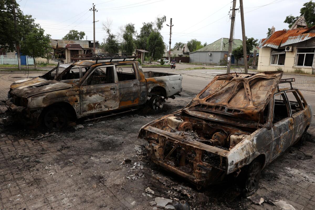 The charred wrecks of cars destroyed by a cluster missile strike in Ukraine