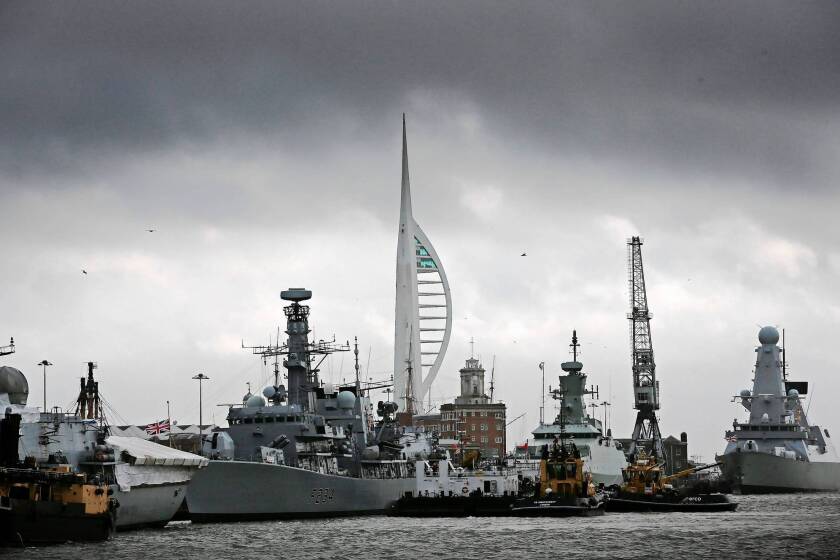 Ships are docked at a naval base in Portsmouth, England, which learned recently that it would no longer be building Britain's naval fleet. It will continue to service vessels, however.