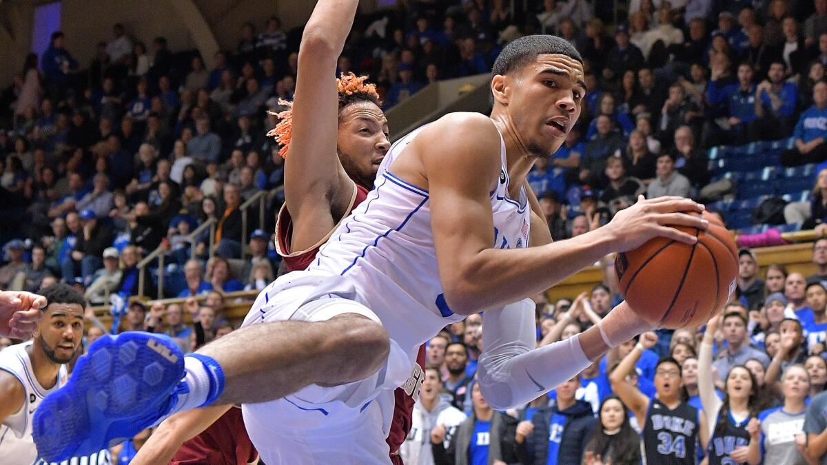 Duke's Jayson Tatum pulls down a rebound in front of Boston College's Ky Bowman during their game Saturday.
