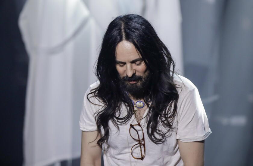 FILE - In this Wednesday, Feb. 19, 2020 file photo, Alessandro Michele acknowledges the applause of the audience at the end of Gucci's Fall/Winter 2020/2021 collection, presented in Milan, Italy. Gucci creative director Alessandro Michele is celebrating the fashion house’s 100-year anniversary, giving historic sweep to a collection unveiled virtually Thursday that embraced its equestrian heritage, borrowed references from the Tom Ford-era and outright stole from a sister brand Balenciaga. (AP Photo/Luca Bruno, File)