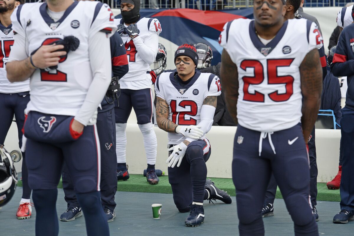Houston Texans wide receiver Kenny Stills kneels during the national anthem on Dec. 15.