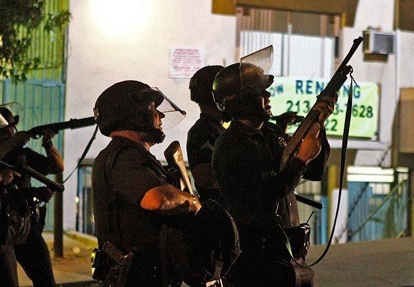 Officers fire non-lethal projectiles at protesters near Union Avenue and 6th Street. Several officers suffered minor injuries after being hit by bottles and rocks, police said. At least 22 people were arrested on charges such as failure to disperse, said LAPD Sgt. Alex Chogyoji. See full story