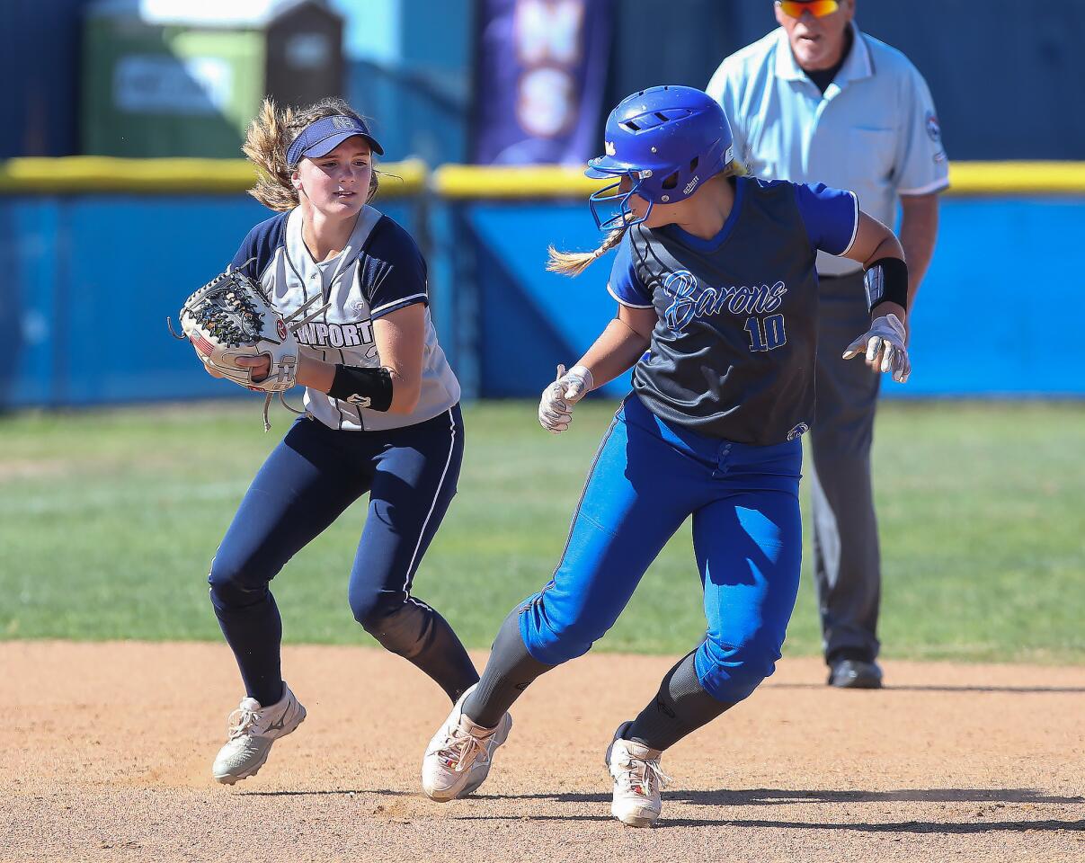 Newport Harbor's Lindsey Blanchfield, left, catches Fountain Valley's Brooke Pace in a rundown between second and third base during a Wave League game at Fountain Valley on Wednesday.