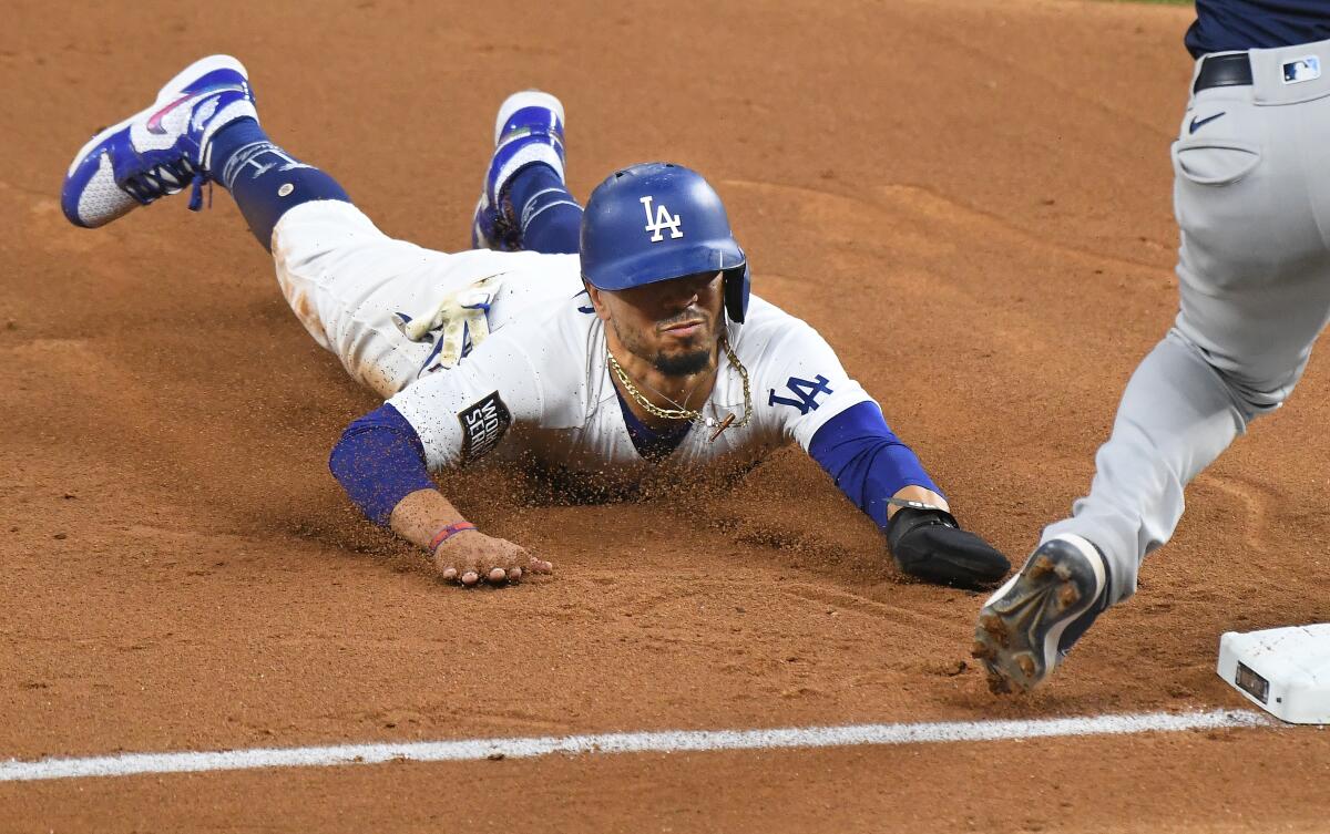 Dodgers baserunner Mookie Betts steals third base during the fifth inning.