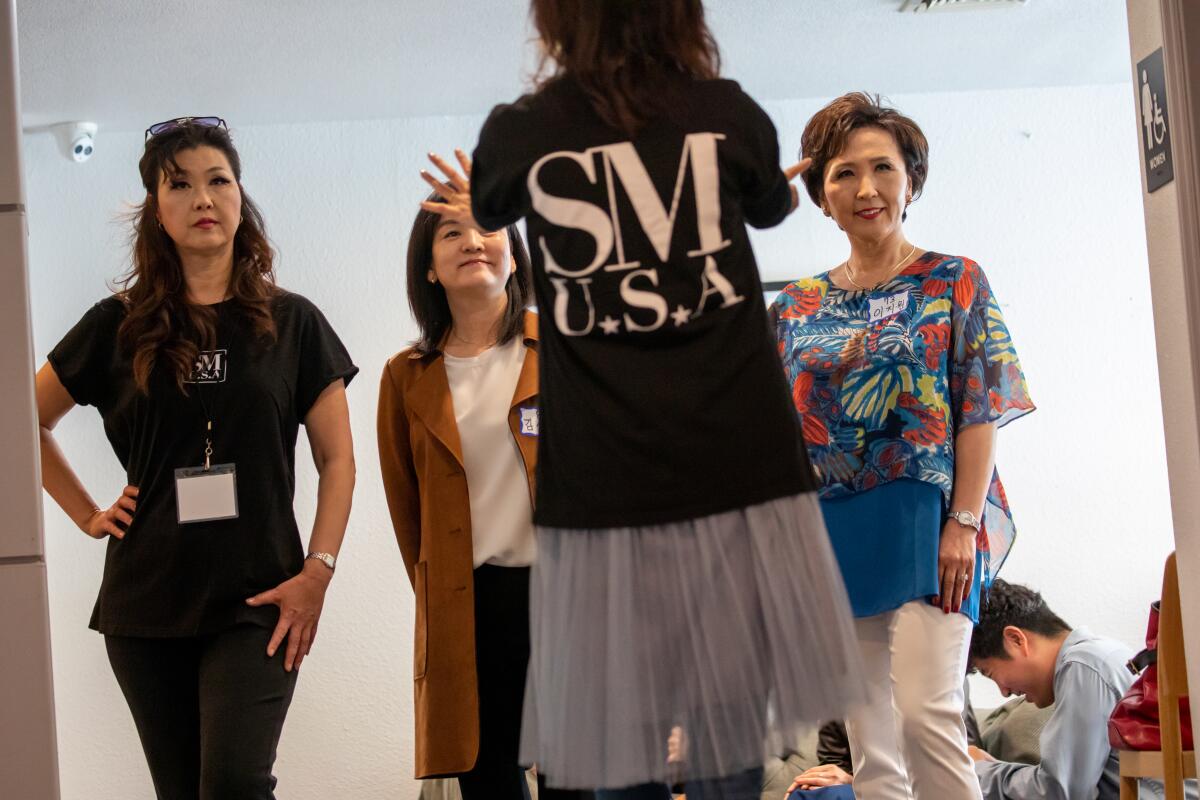 Some of the aspiring senior models get instruction from an expert during the Silver Models USA audition.
