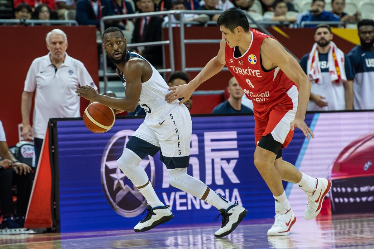 Kemba Walker of the U.S. tries to get past Turkey's Ersan Ilyasova as U.S. coach Gregg Popovich looks on Tuesday night during FIBA World Cup action in Shanghai.