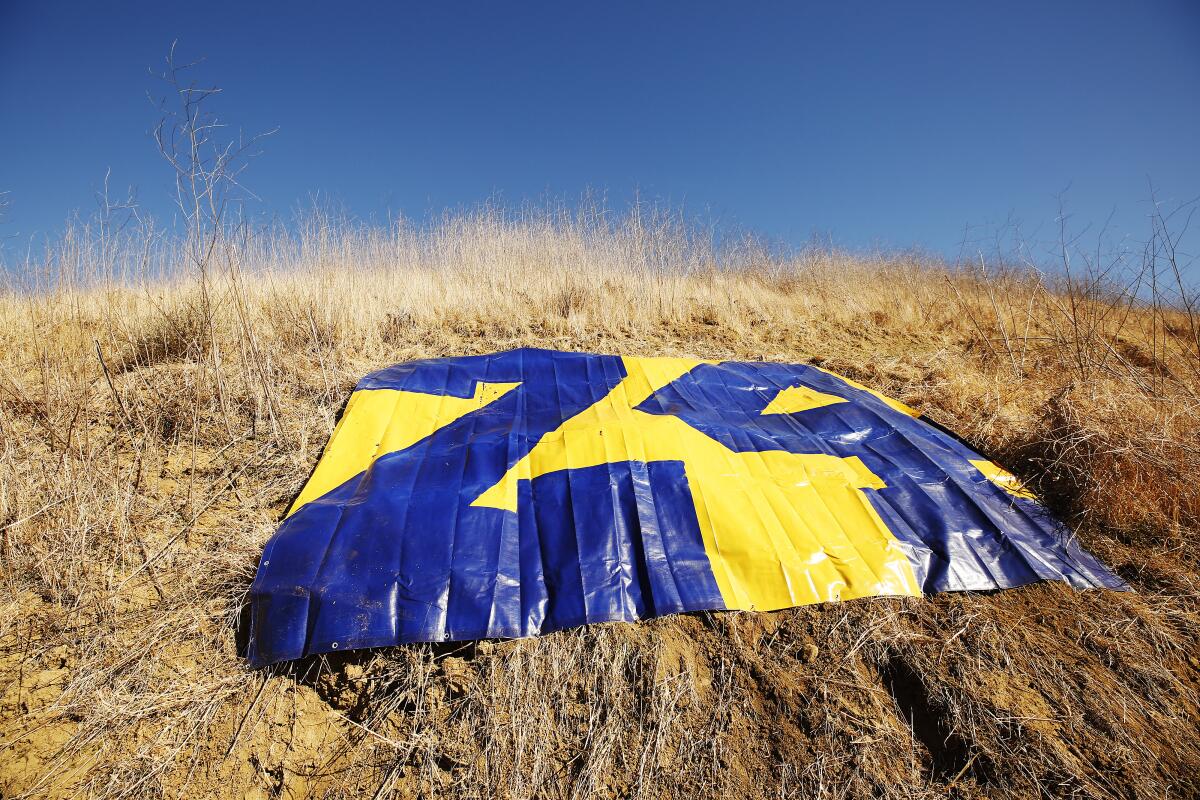 A tarp painted with Kobe Bryant's No. 24 where a helicopter crashed one year ago killing Bryant and eight others. 