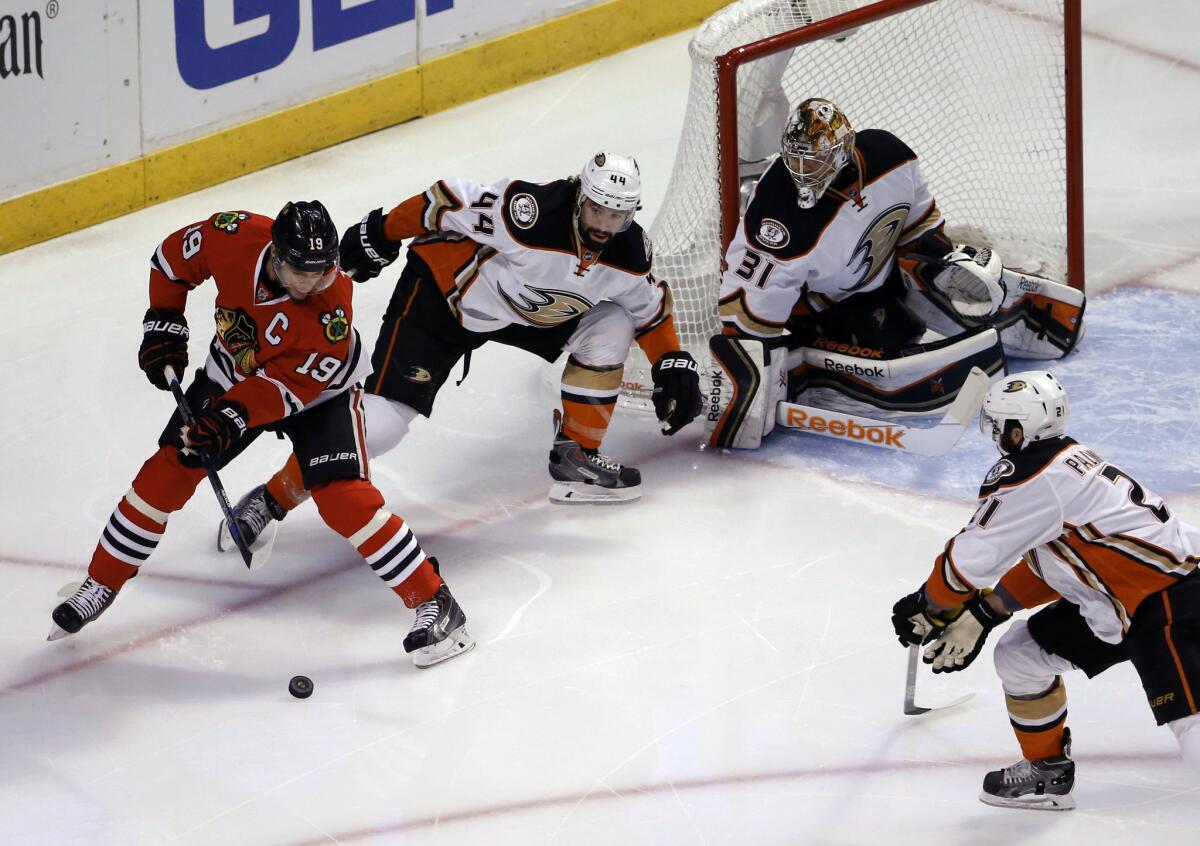 Blackhawks forward Jonathan Toews tries to control the puck in front of Ducks forwards Nate Thompson and Kyle Palmieri during Game 3 of the Western Conference finals.