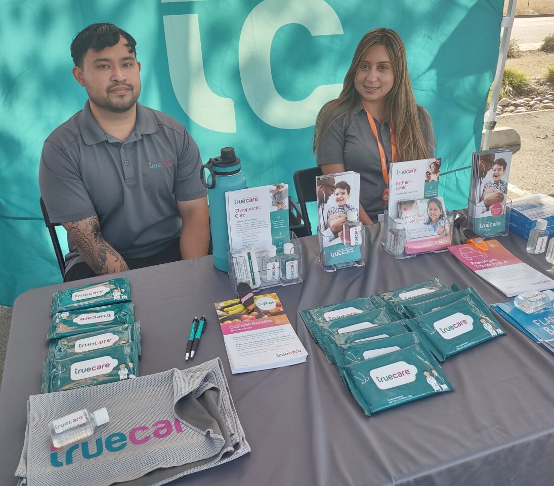 TrueCare Community Health Outreach Workers Daniel Hallman and Diana Robles provide information about health services and resources.