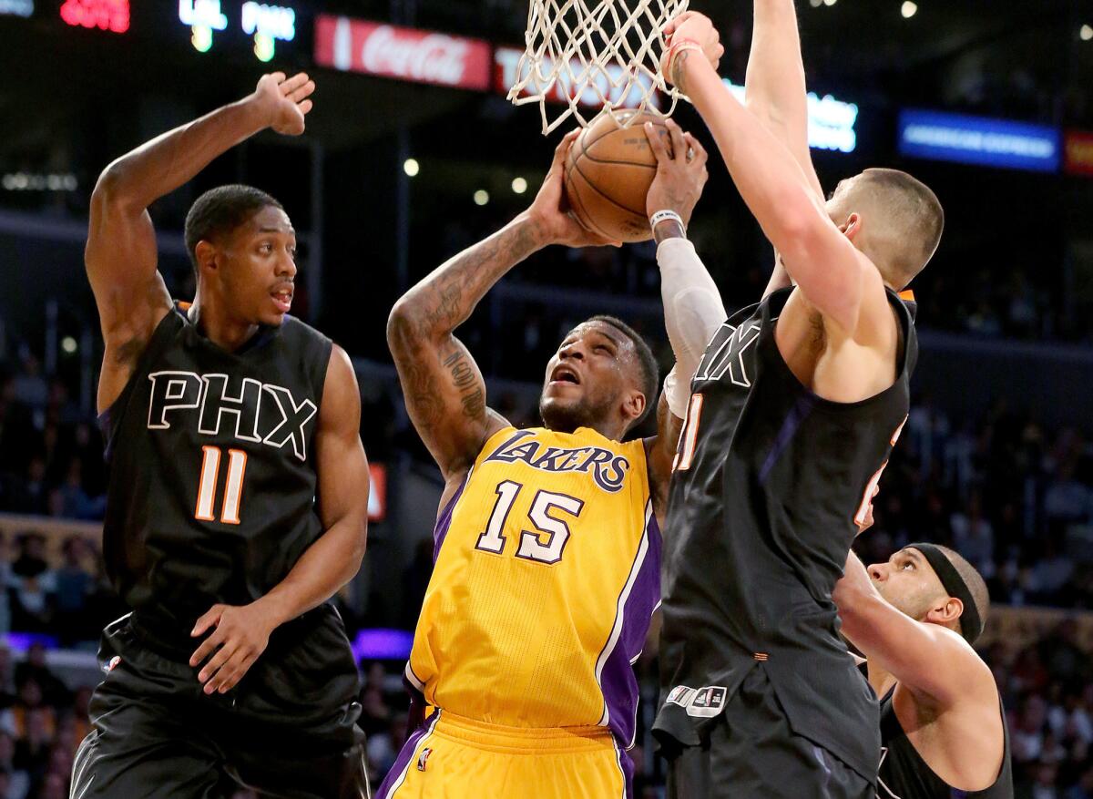 Lakers forward Thomas Robinson draws a crowd of Suns defenders in the fourth quarter.