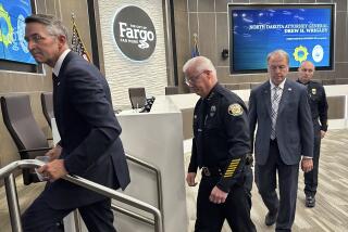 North Dakota Attorney General Drew Wrigley, Fargo Police Chief David Zibolski, Fargo Mayor Tim Mahoney and Assistant Chief Travis Stefonowicz exit the City Commission Chambers on Friday, July 21, 2023, after a news conference in Fargo, N.D. The man who shot three Fargo police officers and a civilian, killing one of the officers before an officer killed him, searched the internet for terms including “explosive ammo” and “kill fast,” as well as for what crowded area events might be happening in and around North Dakota's largest city, authorities said Friday. (AP Photo/Jack Dura)