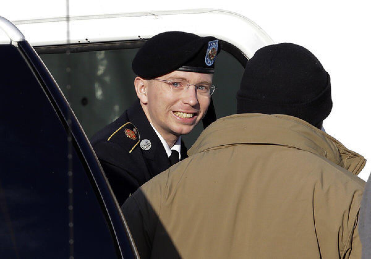 Army Pfc. Bradley Manning, center, steps out of a security vehicle as he is escorted into a courthouse in Ft. Meade, Md., for a pretrial hearing.