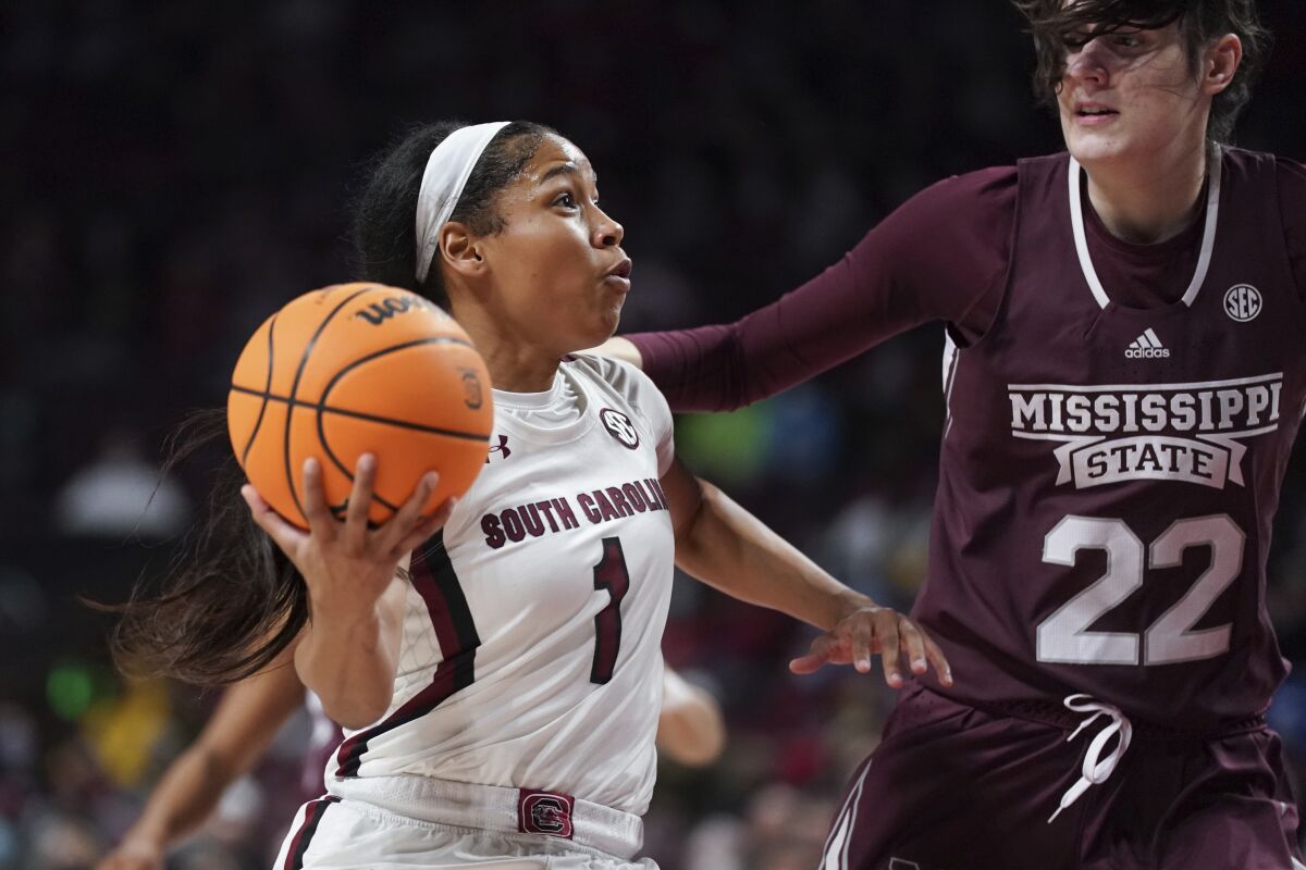 South Carolina guard Zia Cooke (1) drives to the hoop against Mississippi State center Charlotte Kohl (22) during the first half of an NCAA college basketball game Sunday, Jan. 2, 2022, in Columbia, S.C. (AP Photo/Sean Rayford)